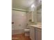 Cozy bathroom with traditional cabinets, tub with white tile surround, and modern finishes at 12512 N 85Th Ave, Peoria, AZ 85381