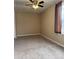 Neutral bedroom featuring a ceiling fan and a window with striped curtains at 12512 N 85Th Ave, Peoria, AZ 85381
