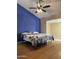Bedroom with a two-tone color scheme, ceiling fan, and wood-look floors at 12512 N 85Th Ave, Peoria, AZ 85381