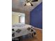 Cozy bedroom featuring a modern quilt, wood-look floors, a ceiling fan and unique two-tone wall at 12512 N 85Th Ave, Peoria, AZ 85381