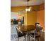 Open dining area with a ceiling fan, colorful walls, and a tiled backsplash in the adjacent kitchen at 12512 N 85Th Ave, Peoria, AZ 85381