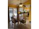 Bright dining area adjacent to the kitchen features a ceiling fan and sliding glass door to the backyard at 12512 N 85Th Ave, Peoria, AZ 85381