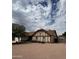Charming single-Gathering home featuring a Tudor-style facade and low-maintenance desert landscaping in the front yard at 12512 N 85Th Ave, Peoria, AZ 85381