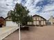 Inviting home with landscaped front yard, white garage door, and beautiful shade tree at 12512 N 85Th Ave, Peoria, AZ 85381