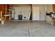 Spacious garage featuring ample storage shelves, a water heater, and plenty of room for parking vehicles at 12512 N 85Th Ave, Peoria, AZ 85381