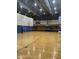 Well-lit indoor gymnasium featuring basketball court with volleyball net at 12512 N 85Th Ave, Peoria, AZ 85381