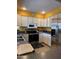 Stainless steel appliances and white cabinets in a bright, well-equipped kitchen, offering modern convenience at 12512 N 85Th Ave, Peoria, AZ 85381