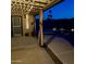 Covered backyard patio with curtains and patio furniture overlooking pool area with lighting and safety floatation device at 12512 N 85Th Ave, Peoria, AZ 85381