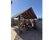 Private backyard with a shaded cabana, comfortable seating, and desert landscaping at 12512 N 85Th Ave, Peoria, AZ 85381