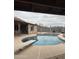Backyard pool with diving board and partially covered patio area perfect for entertaining or relaxing at 12512 N 85Th Ave, Peoria, AZ 85381