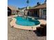 Backyard swimming pool with a hot tub, rock landscaping, and covered patio offers a great space for outdoor entertaining at 12512 N 85Th Ave, Peoria, AZ 85381