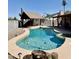 A sparkling pool with a covered lounge area offers a relaxing outdoor oasis in this backyard at 12512 N 85Th Ave, Peoria, AZ 85381