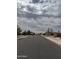 A quiet residential street lined with well-kept homes and mature trees at 12512 N 85Th Ave, Peoria, AZ 85381