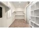 Walk-in closet with custom shelving and storage for optimal organization at 14188 W Hope Dr, Surprise, AZ 85379