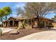 Well-maintained home showcasing desert landscaping and a circular driveway at 14188 W Hope Dr, Surprise, AZ 85379