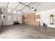 Spacious garage with custom cabinets, sink, overhead storage, and room for multiple vehicles and projects at 14188 W Hope Dr, Surprise, AZ 85379