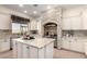 Well-appointed kitchen with granite countertops, a center island, and a view of the outdoor landscape at 14188 W Hope Dr, Surprise, AZ 85379