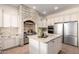 Modern kitchen with white cabinets, stainless steel appliances, and a brick alcove housing the stove and oven at 14188 W Hope Dr, Surprise, AZ 85379