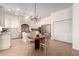 Spacious kitchen with white cabinetry, stainless steel appliances, and a breakfast nook with a round table at 14188 W Hope Dr, Surprise, AZ 85379