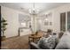 Comfortable living room with a cozy seating area, neutral tones, and an open view to other living spaces at 14188 W Hope Dr, Surprise, AZ 85379