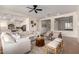 Open-concept living room featuring a large sofa, stylish decor, and seamless flow to other areas of the home at 14188 W Hope Dr, Surprise, AZ 85379
