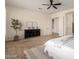A spacious main bedroom featuring neutral walls, ceiling fan, black console and carpet at 14188 W Hope Dr, Surprise, AZ 85379