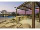Backyard featuring a pool, built-in grill, desert landscaping, and a covered patio at 14188 W Hope Dr, Surprise, AZ 85379