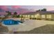 Beautiful backyard featuring a pool, covered patio, and desert-friendly landscaping at 14188 W Hope Dr, Surprise, AZ 85379