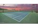 Enjoy a private tennis court with ample lighting for evening play and a beautiful sunset backdrop at 14188 W Hope Dr, Surprise, AZ 85379