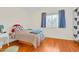 Bedroom with wood floors, a large window, and neutral wall color at 155 W Knox Rd, Tempe, AZ 85284