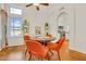 Bright dining room area with wood floors, modern light fixture, and plenty of natural light at 155 W Knox Rd, Tempe, AZ 85284