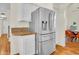 Modern kitchen featuring stainless steel refrigerator, granite countertops, and white cabinets at 155 W Knox Rd, Tempe, AZ 85284