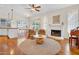 Cozy living room featuring hardwood floors, fireplace, and comfortable seating arrangement at 155 W Knox Rd, Tempe, AZ 85284