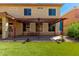 Backyard with synthetic grass, desert landscaping, and covered patio with pergola at 16022 W Desert Mirage Dr, Surprise, AZ 85379