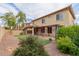Backyard with artificial grass, desert landscaping, covered patio and pergola at 16022 W Desert Mirage Dr, Surprise, AZ 85379