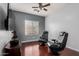 Bonus room features two gaming chairs, a ceiling fan, and a wall-mounted TV at 16022 W Desert Mirage Dr, Surprise, AZ 85379