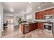 Open kitchen with stainless steel appliances, a large island, and easy access to the outdoor patio at 16022 W Desert Mirage Dr, Surprise, AZ 85379