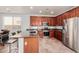 Modern kitchen with stainless steel appliances, granite countertops, and a spacious island with bar seating at 16022 W Desert Mirage Dr, Surprise, AZ 85379