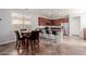 Modern kitchen with stainless steel appliances, a large island with seating, and an adjacent dining area at 16022 W Desert Mirage Dr, Surprise, AZ 85379