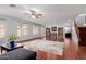 Spacious living room featuring hardwood floors, ample natural light, and stylish decor at 16022 W Desert Mirage Dr, Surprise, AZ 85379
