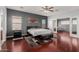 Spacious main bedroom with a ceiling fan and views into the sitting room at 16022 W Desert Mirage Dr, Surprise, AZ 85379