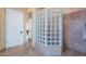 Bathroom with a glass block accent piece, tiled floors, and shower on the right at 16441 S Mountain Stone Trl, Phoenix, AZ 85048