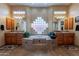 Elegant primary bathroom with and vanities and a soaking tub with tile surround at 16441 S Mountain Stone Trl, Phoenix, AZ 85048