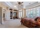 Primary bedroom with plantation shutters, carpet, and built-ins with doors to the backyard at 16441 S Mountain Stone Trl, Phoenix, AZ 85048