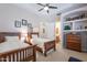 A bedroom featuring two twin beds, ceiling fan, and artwork at 16441 S Mountain Stone Trl, Phoenix, AZ 85048