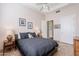 A cozy bedroom featuring a ceiling fan, two side tables with lamps, and a king bed at 16441 S Mountain Stone Trl, Phoenix, AZ 85048