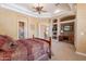 Large primary bedroom with ceiling fan, carpet, built-ins, and an ensuite bathroom in view at 16441 S Mountain Stone Trl, Phoenix, AZ 85048