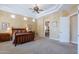 Spacious primary bedroom with a beamed ceiling, neutral carpet, and an ensuite bathroom in view at 16441 S Mountain Stone Trl, Phoenix, AZ 85048