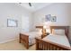 Bedroom showcasing two twin beds, neutral decor, and tasteful wall art at 16441 S Mountain Stone Trl, Phoenix, AZ 85048