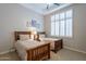 Bedroom with two beds, plantation shutters, ceiling fan, and neutral decor at 16441 S Mountain Stone Trl, Phoenix, AZ 85048